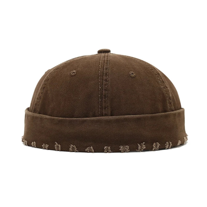 Brown beanie with embroidered patterns on a white background