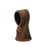 Brown knitted balaclava on a light beige background