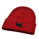 Red beanie with a black cat embroidered on a white background