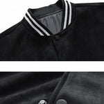 Close-up of a black jacket with white trim and buttons, featuring text on a white background.