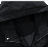 Close-up of a black hooded jacket with a zipper on a white background