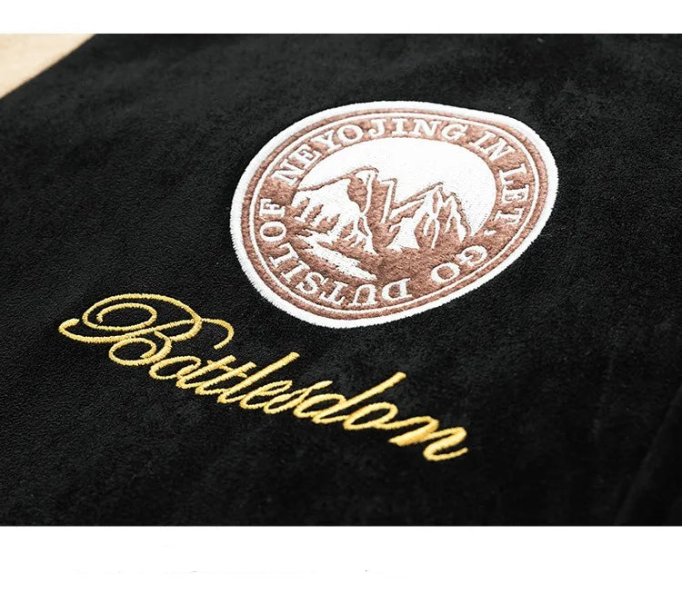 Close-up of a black surface with an embroidered logo and text.