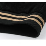 Close-up of black fabric with beige stripes on a white background