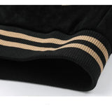 Close-up of black fabric with beige stripes on a white background