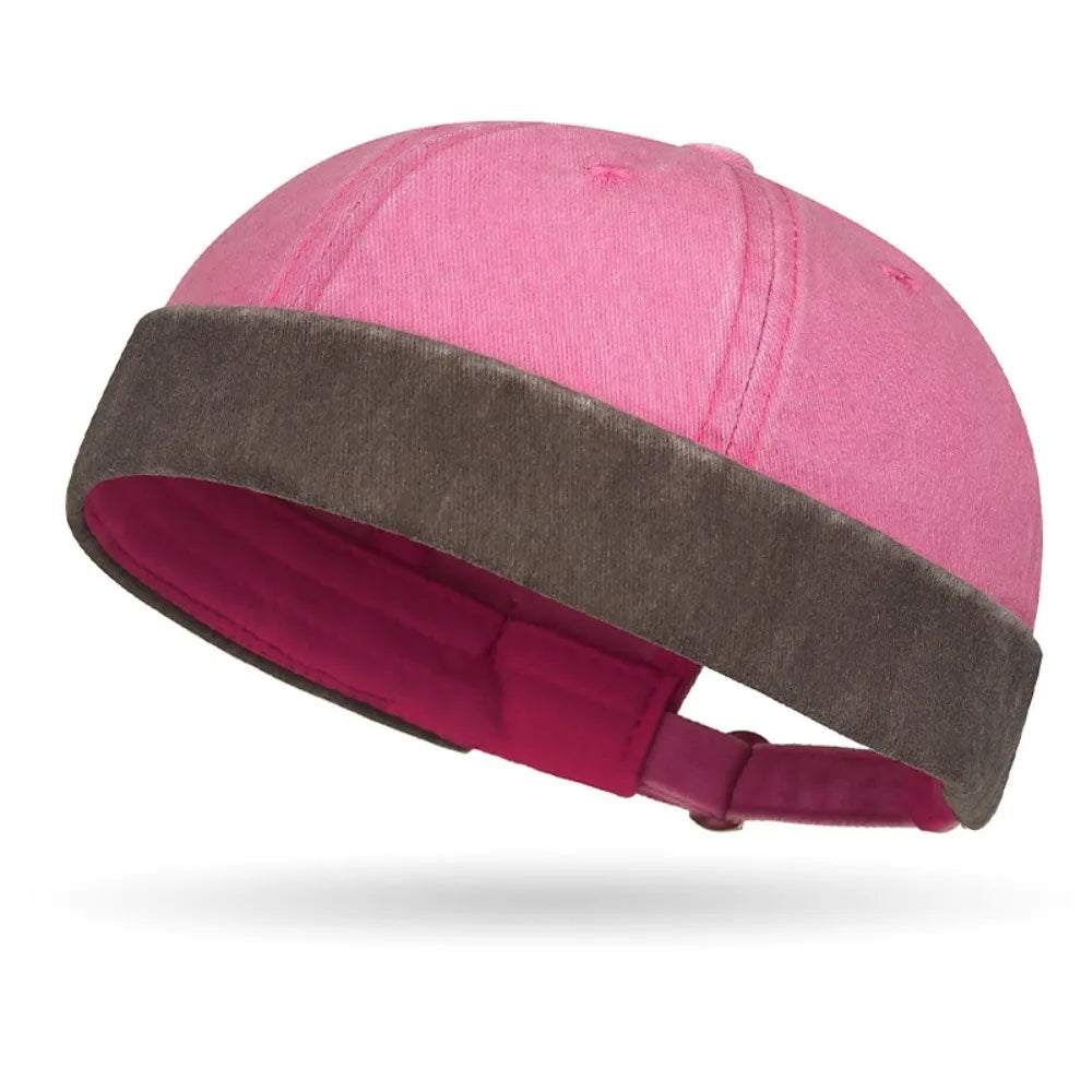 Pink and brown baby bonnet on a white background