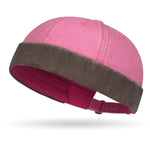 Pink and brown baby bonnet on a white background