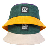 Color-blocked bucket hat with cat logo on a white background