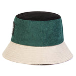 Two-toned bucket hat with green top and beige bottom on a white background