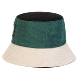 Two-toned bucket hat with green top and beige bottom on a white background