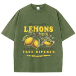 Dark green lemon graphic tee on model, cropped lifestyle shot showing fit