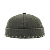 Dark green beanie with patterned band on a white background