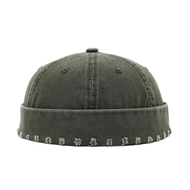 Dark green beanie with patterned band on a white background