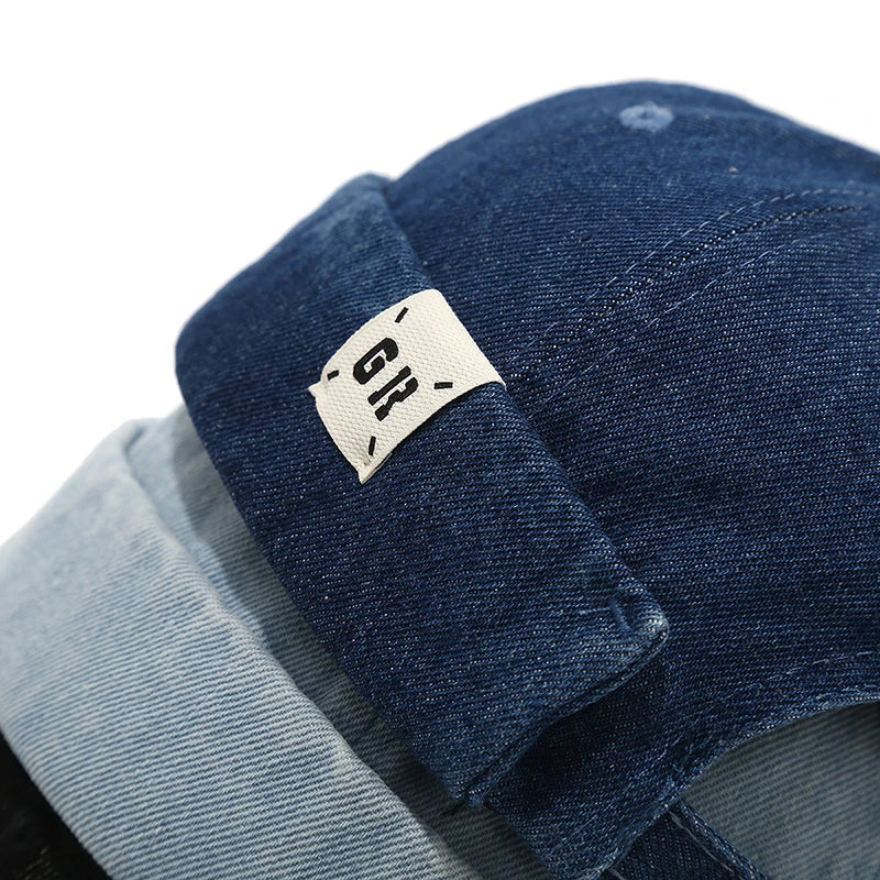 Close-up of a blue denim product with a brand label on a white background