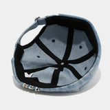 Distressed denim docker cap worn, front view