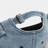 Distressed denim docker cap worn, side view