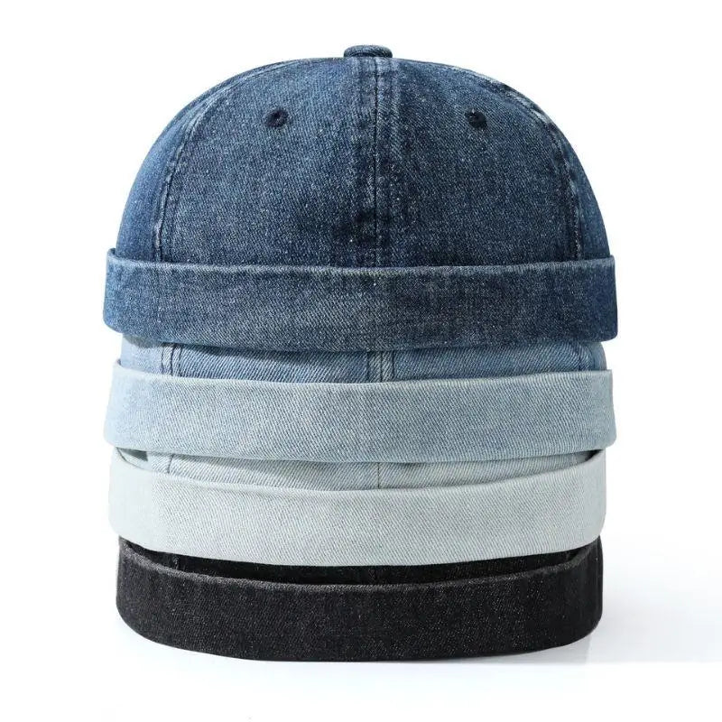 Stack of denim hats in various shades on a white background