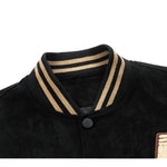 Close-up of a black sweater with beige trim on a white background