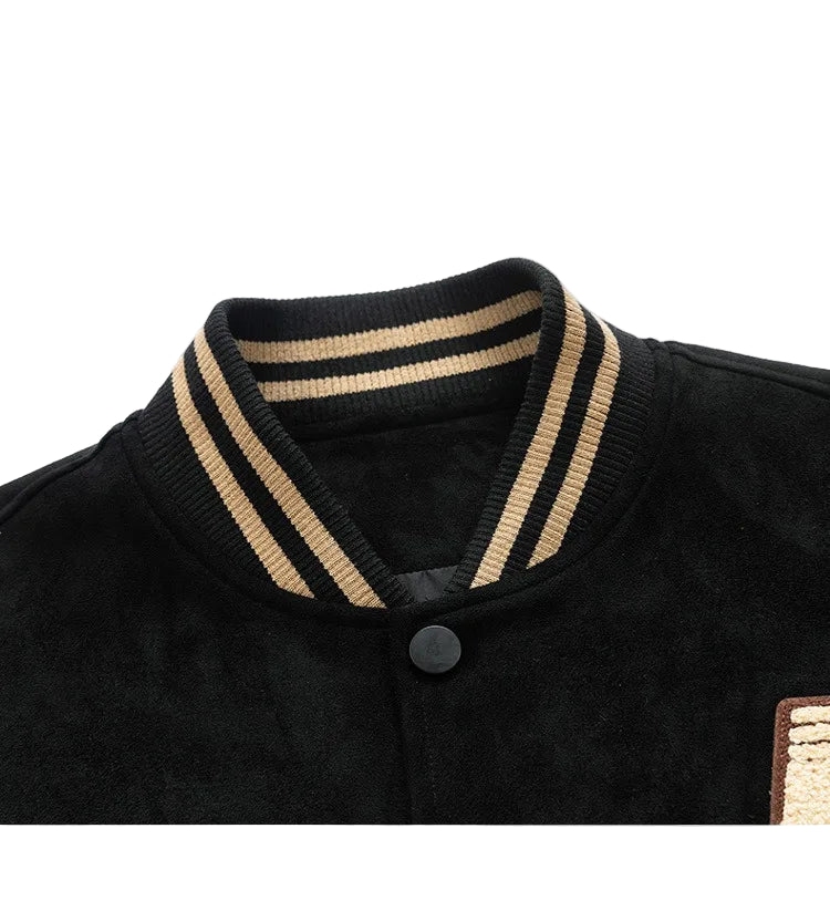 Close-up of a black sweater with beige trim on a white background