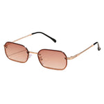 Sunglasses with a gold frame and brown gradient lenses on a light beige background