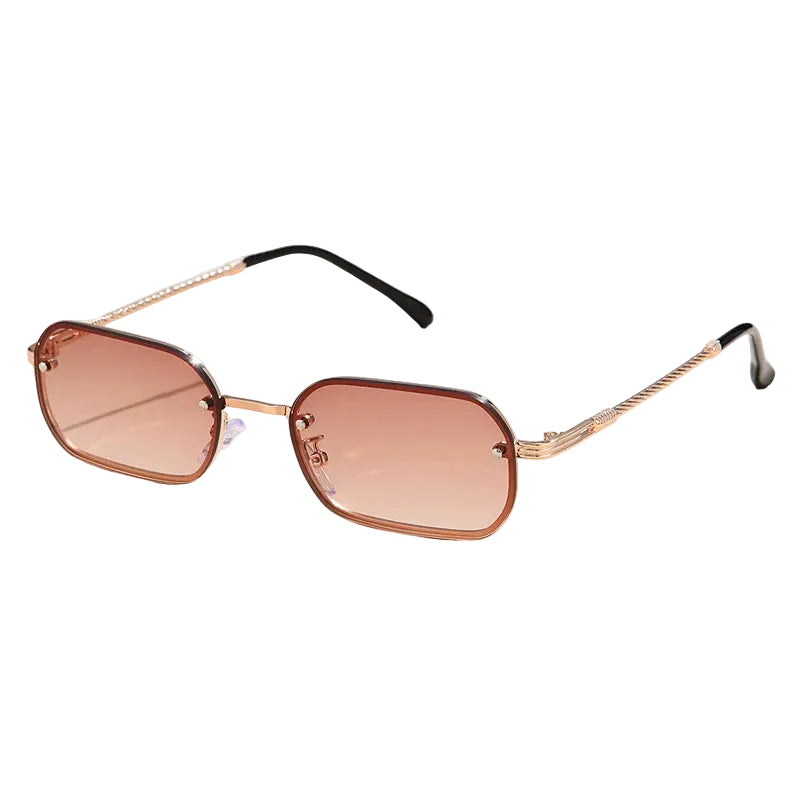 Sunglasses with a gold frame and brown gradient lenses on a light beige background