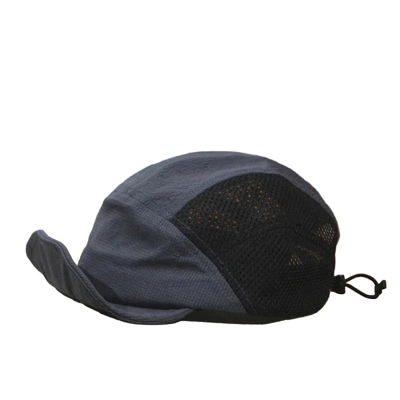 Blue and black cap on an open book with a wooden surface and beige wall background