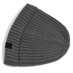 Gray knit beanie with a black tag on a white background