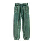 Green Men's baggy washed fleece sweatpants — worn close-up