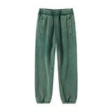 Green Men's baggy washed fleece sweatpants — worn close-up