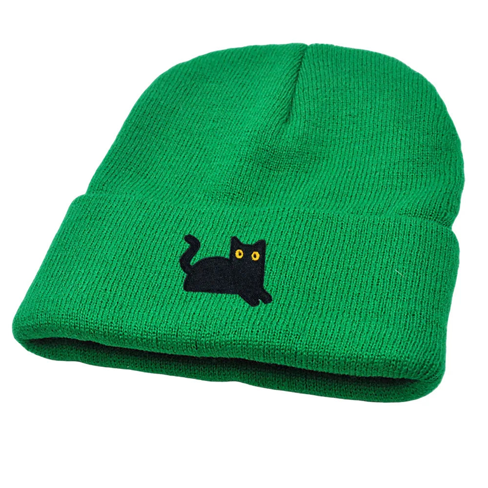 Green beanie with a black cat design on a white background