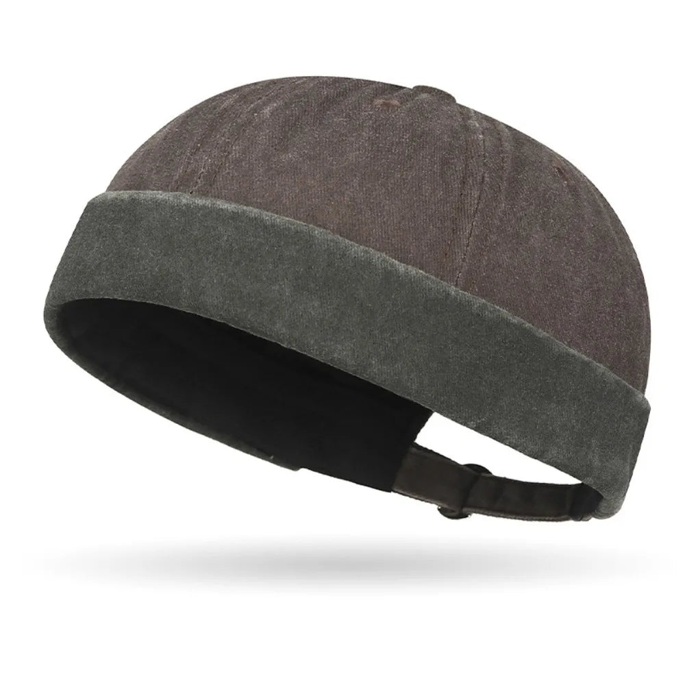 Dark gray beanie with a green band on a white background