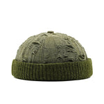 Green knit beanie with distressed texture on a white background