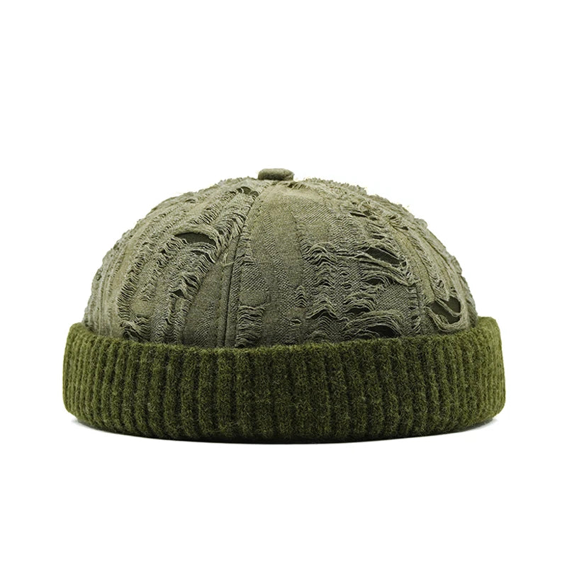 Green knit beanie with distressed texture on a white background