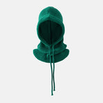 Green knitted balaclava on a light gray background