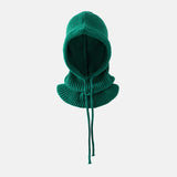 Green knitted balaclava on a light gray background