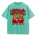 Green-Xy379 Model in loose fit cherry leopard O-neck graphic tee, outdoor
