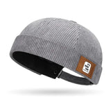 Grey Brimless corduroy docker cap styled in casual streetwear look