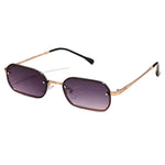 Sunglasses with gold frame and purple lenses on a light beige background