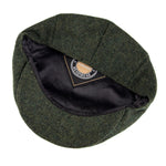 Herringbone tweed flat cap worn, side view