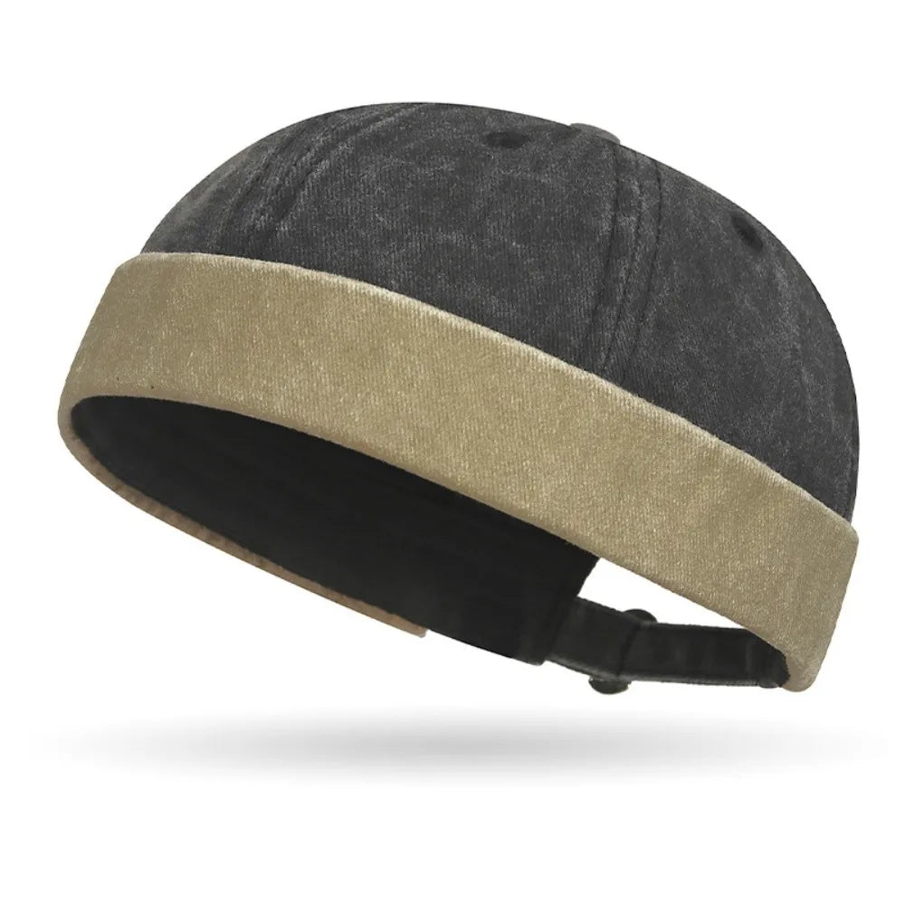 Two-toned cap with dark gray top and beige band on a white background