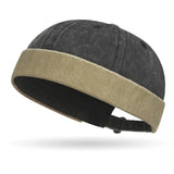 Two-toned cap with dark gray top and beige band on a white background