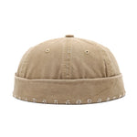 Khaki cap with embroidered details on a white background