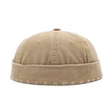 Khaki cap with embroidered details on a white background