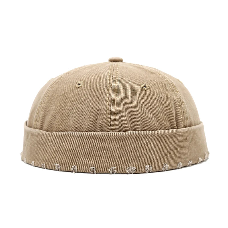 Khaki cap with embroidered details on a white background