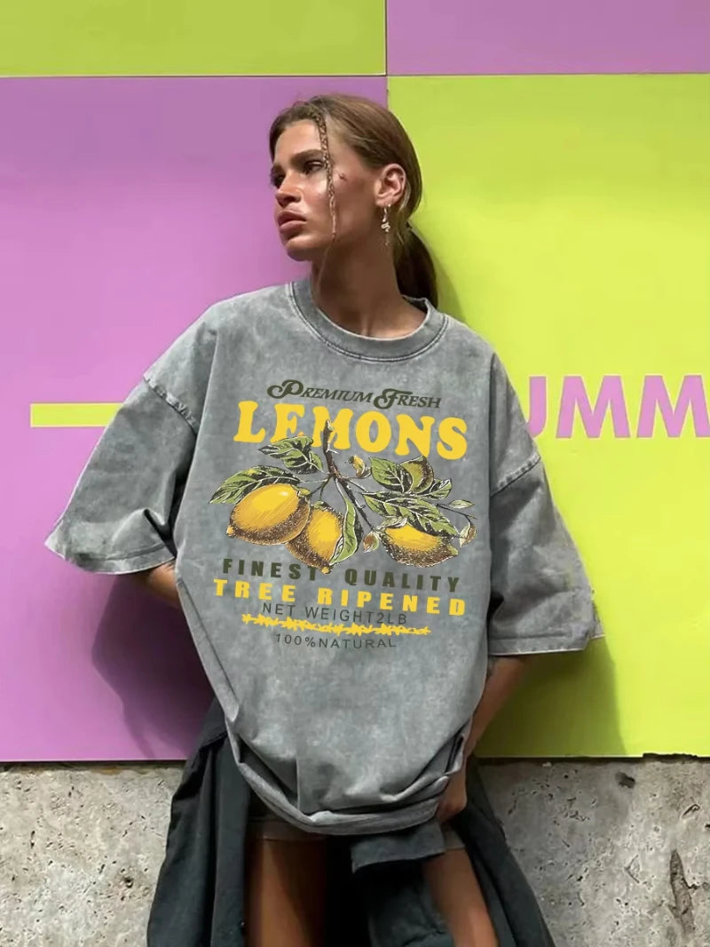 Close-up detail of lemon graphic print and vintage wash texture on cotton tee