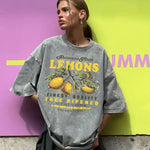 Close-up detail of lemon graphic print and vintage wash texture on cotton tee
