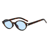 Leopard Blue Close-up of model wearing small oval retro sunglasses — frame and fit detail