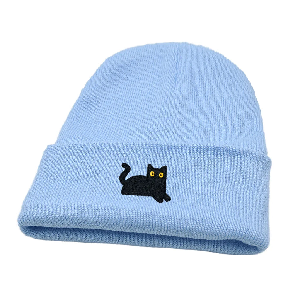 Light blue beanie with a black cat embroidery on a white background