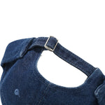 Close-up of a blue denim dog harness on a white background