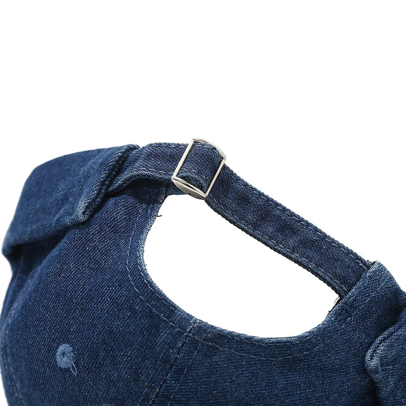 Close-up of a blue denim dog harness on a white background