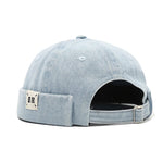 Light blue denim cap with a patch on a white background
